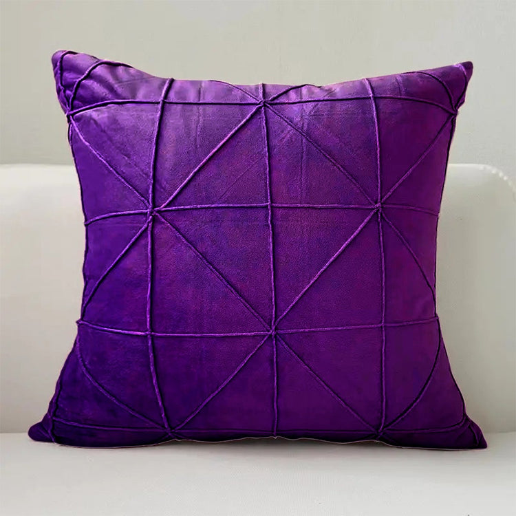 Purple cushion cover with intersecting geometric stitched lines.