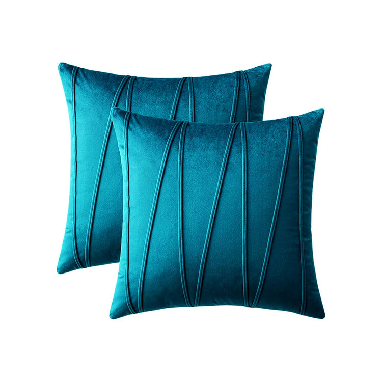 Two teal cushion covers with long angular stitched lines.