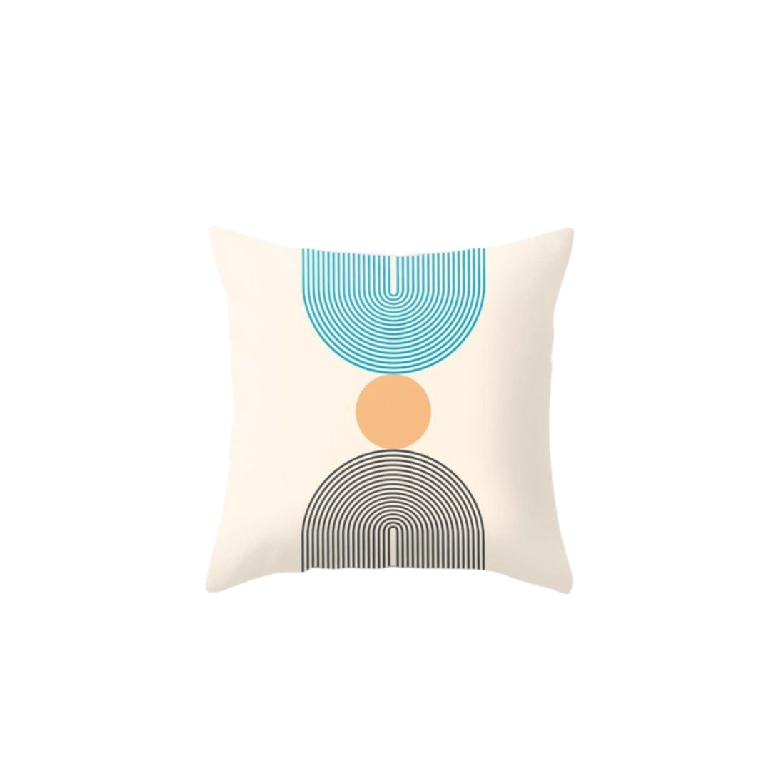 Cream cushion cover with teal and grey lined semicircles and a peach circle.