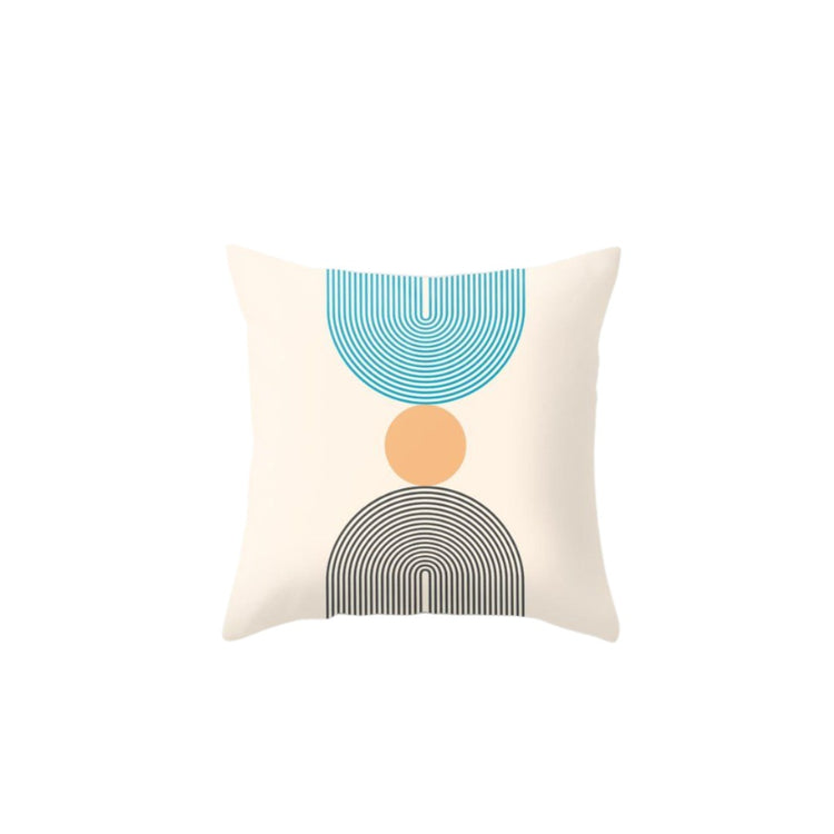 Cream cushion cover with teal and grey lined semicircles and a peach circle.
