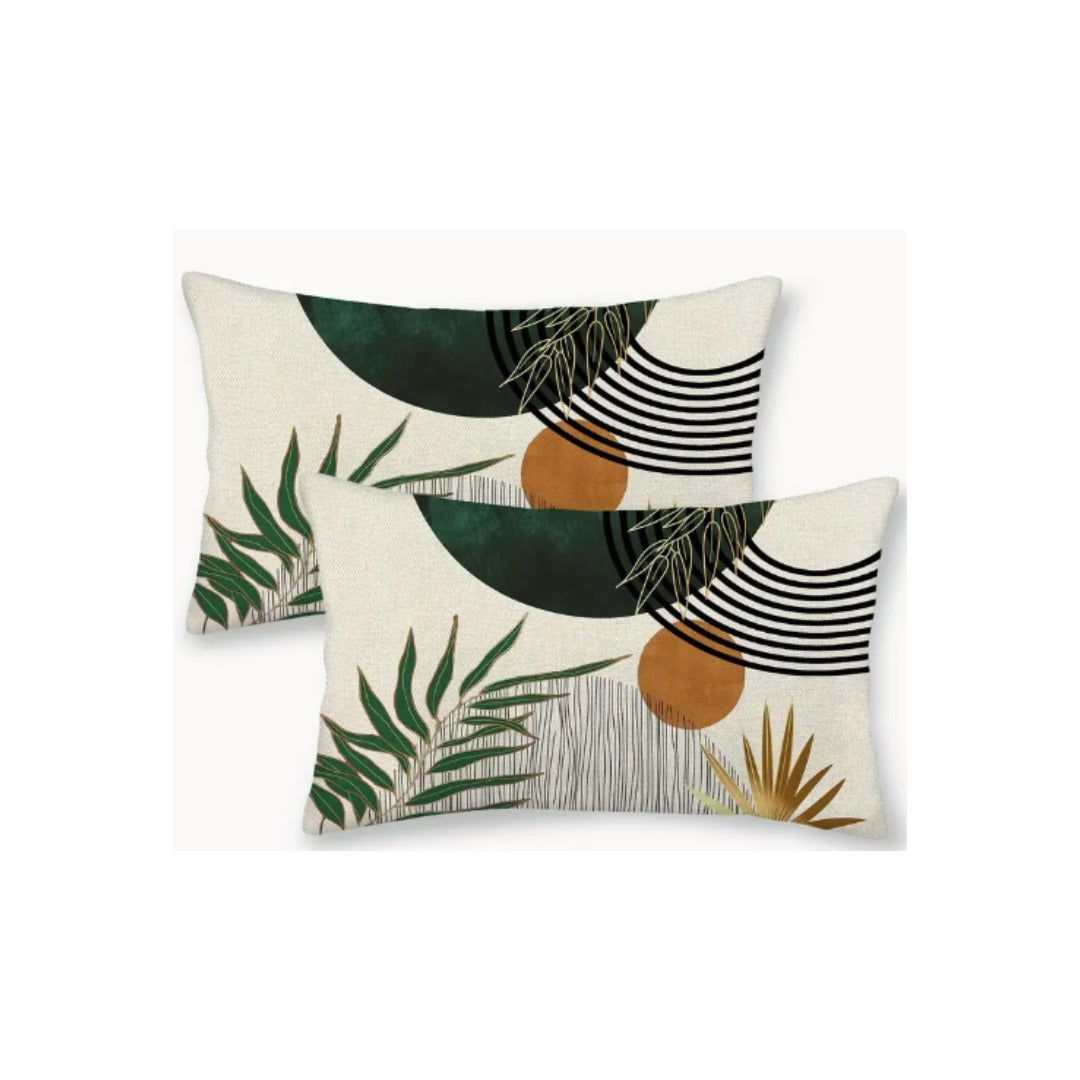 Two rectangular cream cushion covers with green leaves, ochre circles and black curved lines.