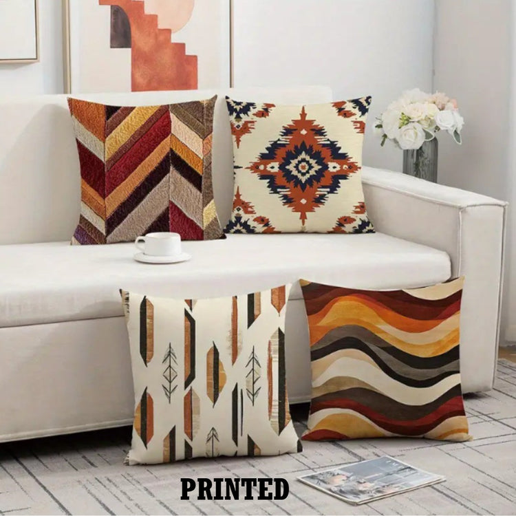 Four earthy patterned cushion covers with chevrons, diamonds and waves on a sofa.