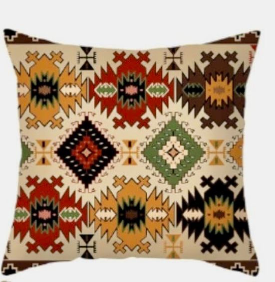 Cream cushion cover with a dense pattern of colourful stepped diamonds and small motifs.