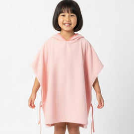 Child wearing a plain pink hooded towel poncho.