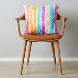 Rainbow-striped decorative cushion on a wooden chair.