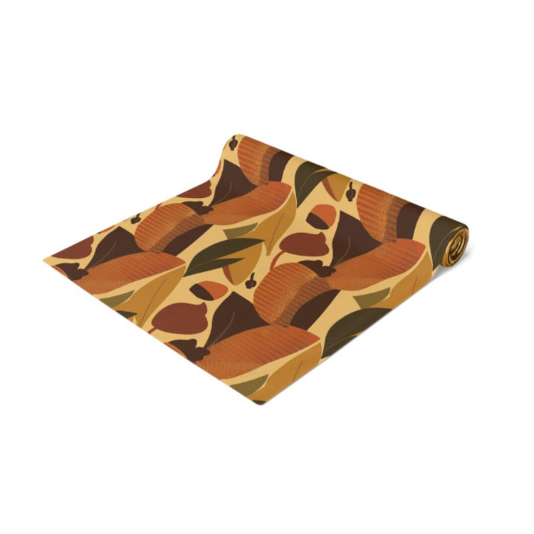 Folded multicoloured autumn leaf-pattern table runner.