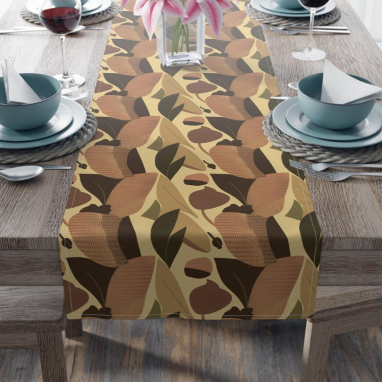 Table runner with abstract autumn leaves in orange, mustard, brown and olive.