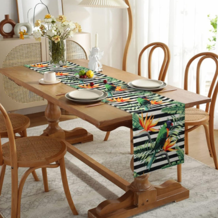 Dark striped table runner with colourful tropical flowers and leaves.