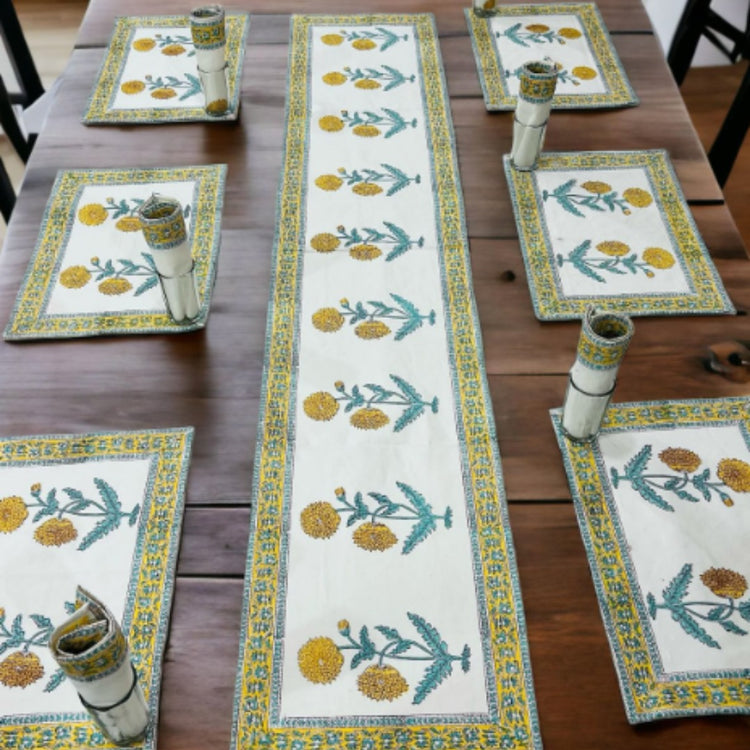 Cream table runner with yellow flowers, green leaves and matching placemats.