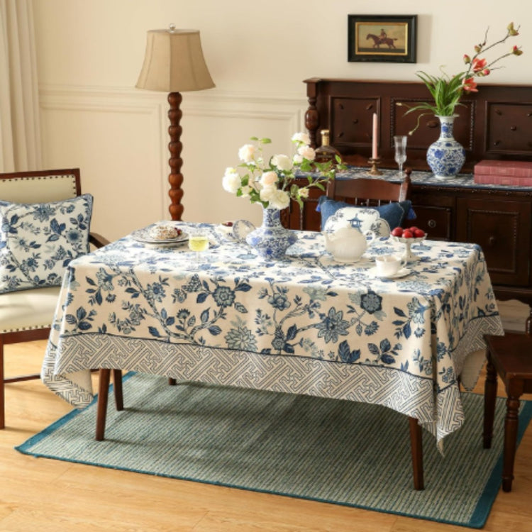Cream tablecloth with blue flowers and a grey geometric border.