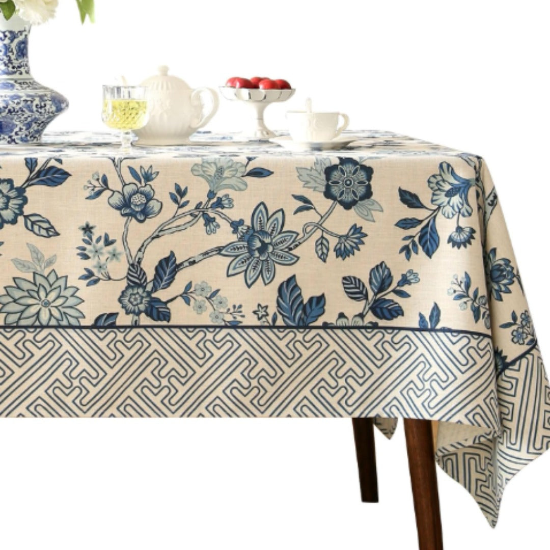 Cream tablecloth with blue flowers and a grey geometric border.