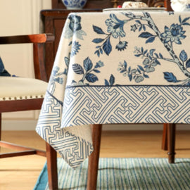 Cream tablecloth with blue flowers and a grey geometric border.