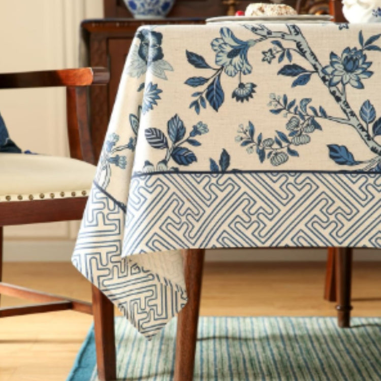 Cream tablecloth with blue flowers and a grey geometric border.