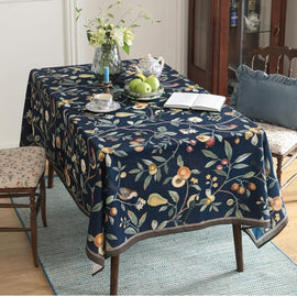 Navy tablecloth with colourful botanical vines and fruit motifs.