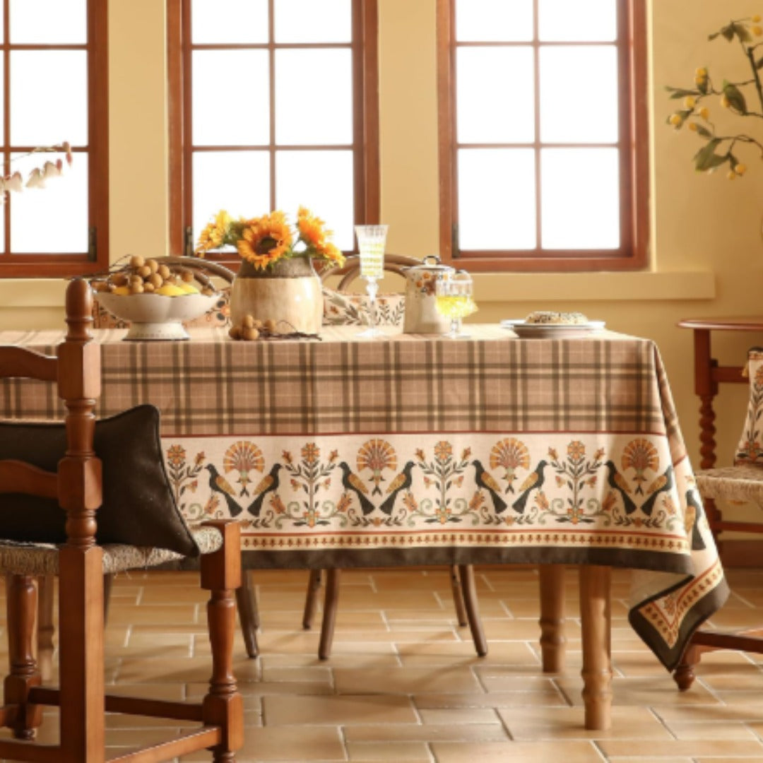 Brown checked tablecloth with a cream botanical border.