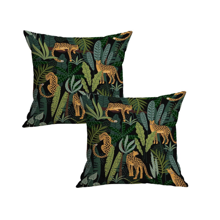 Two black cushion covers with golden leopards among green leaves.