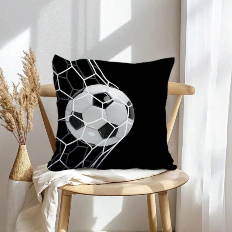 Black cushion cover with a white football and goal-net design on a wooden chair.