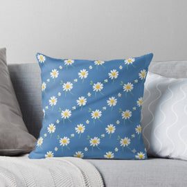 Blue cushion cover with small white daisies and yellow centres.