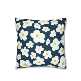 Navy cushion cover with rounded white and pale blue flowers and yellow centres.
