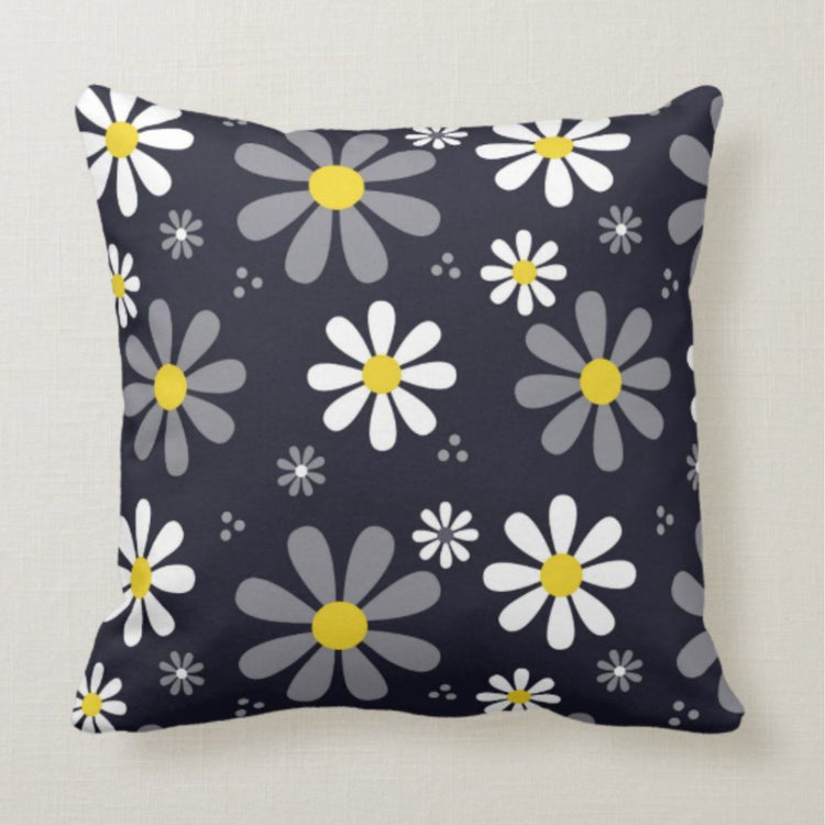 Dark grey cushion cover with scattered white and grey daisies and yellow centres.