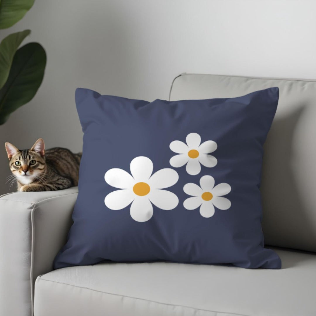 Navy cushion cover with a cluster of white daisies and yellow centres.