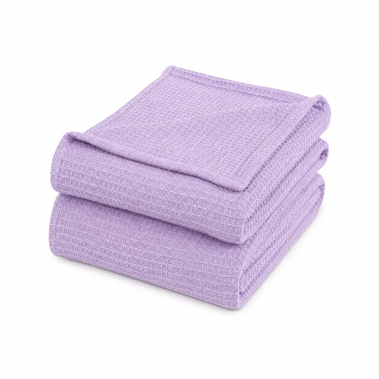 Folded lilac waffle-weave cotton thermal blanket.