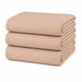 Stack of folded beige waffle-textured blankets on a white background.