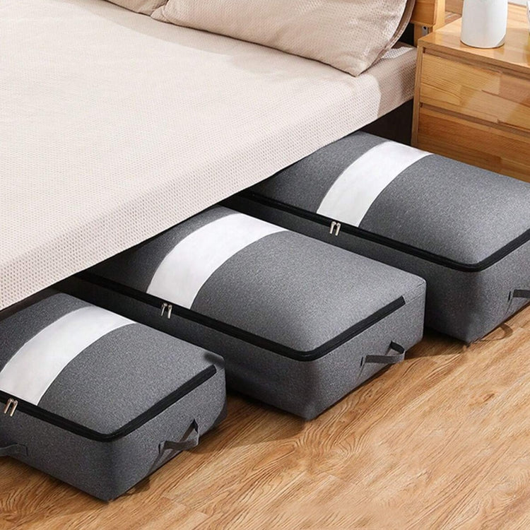 Grey flat quilt-storage bags arranged beneath a bed.