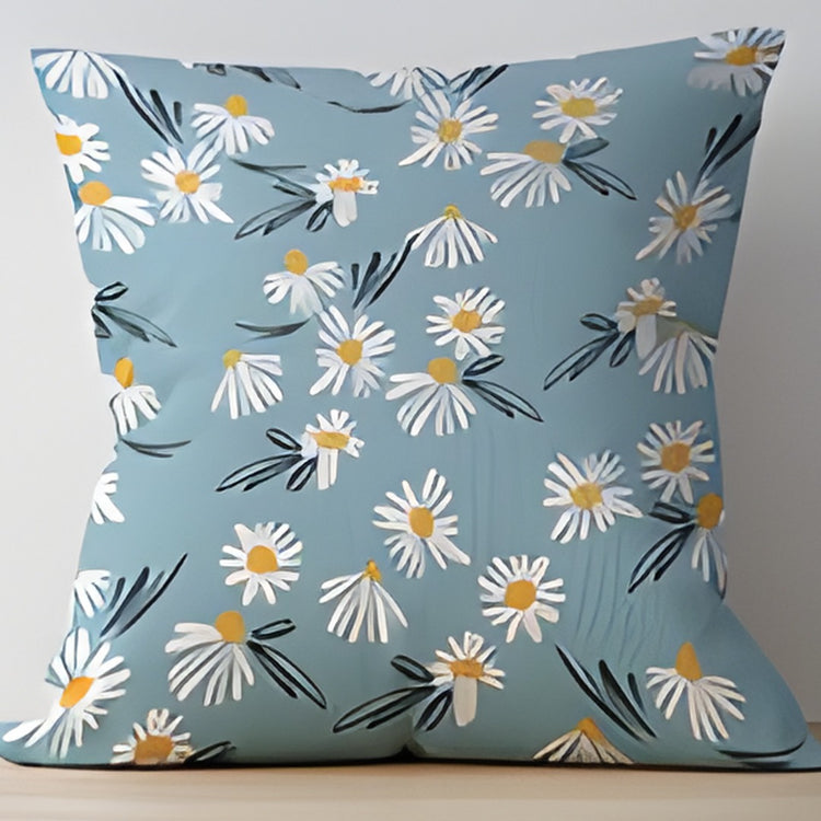 Light blue cushion cover with small white daisies and slender dark stems.
