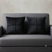 Two black cushion covers with geometric panel stitching on a grey sofa.