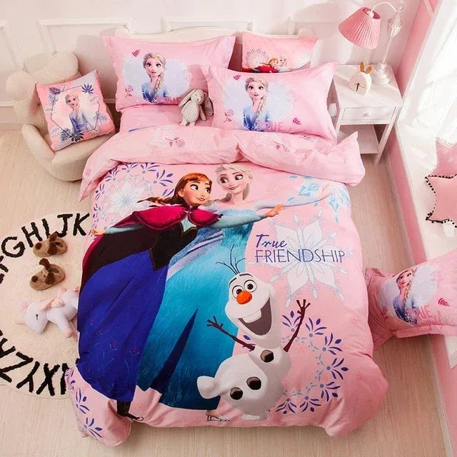 Pink children's bedsheet and pillowcases featuring animated princesses and a snowman.