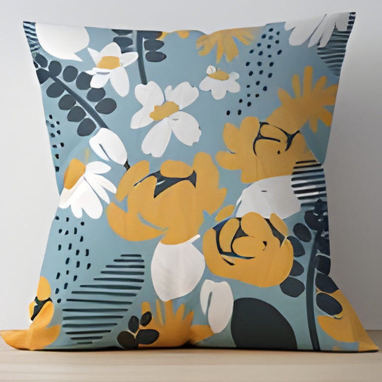 Pale blue cushion cover with large yellow and white flowers and dark leaves.