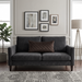 Rectangular brown filled cushion with diamond stitching on a dark grey sofa.