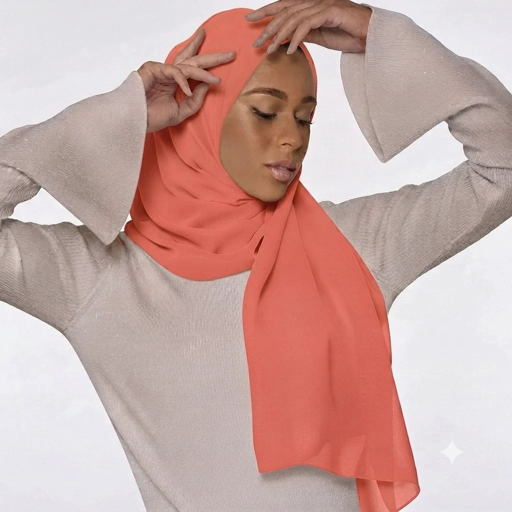Model wearing a plain coral chiffon stole as a headscarf.