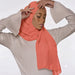 Model wearing a plain coral chiffon stole as a headscarf.
