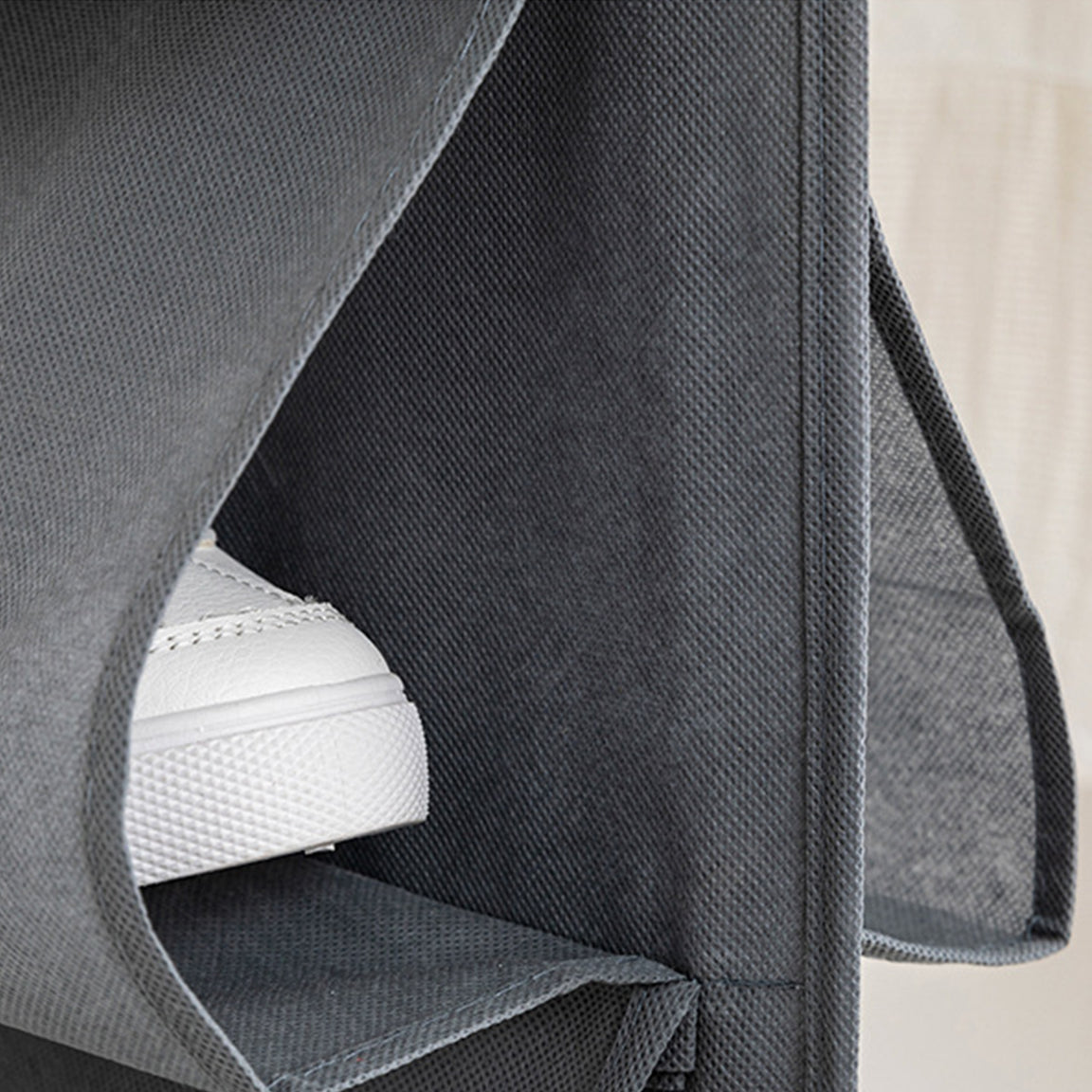 Close-up of a shoe inside a fabric organizer pocket.