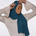 Model wearing a plain teal chiffon stole as a headscarf.