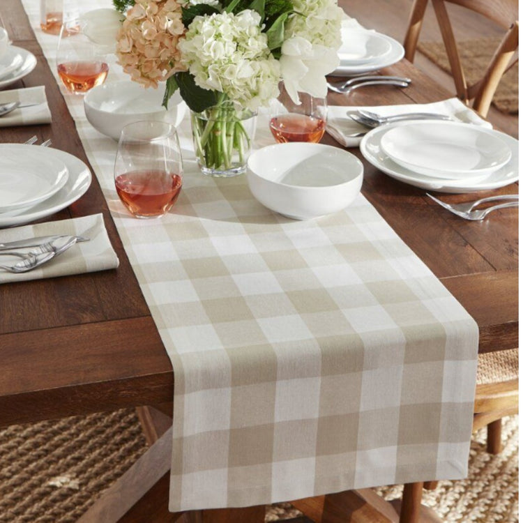 Cream and beige checked table runner on a set dining table.