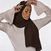 Model wearing a plain brown chiffon stole as a headscarf.