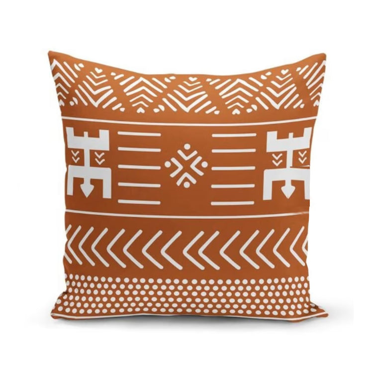 Rust cushion cover with white geometric line motifs and chevron borders.