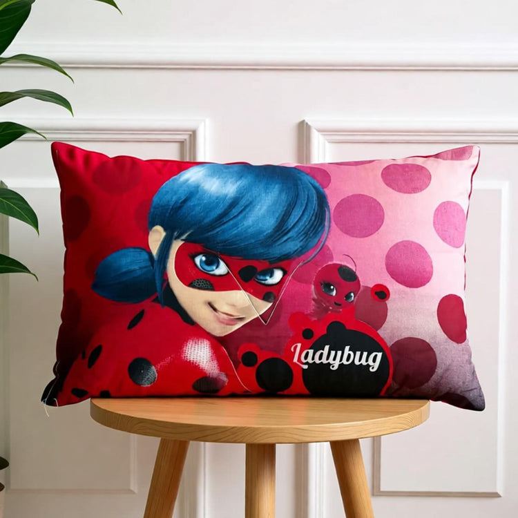 Pink and red Ladybug character cushion cover displayed on a wooden chair.