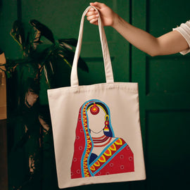 Cream tote bag with an illustrated woman in colourful traditional dress.