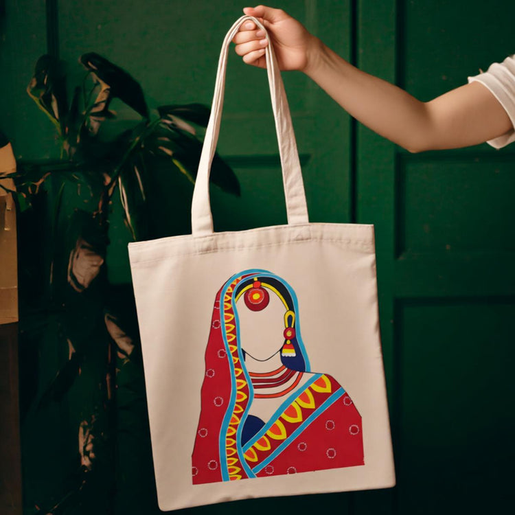 Cream tote bag with an illustrated woman in colourful traditional dress.
