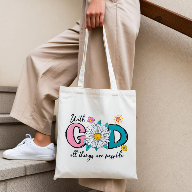 Cream tote bag with colourful faith-themed lettering and small flowers.