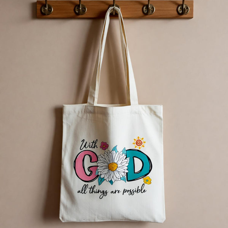 Cream tote bag with colourful faith-themed lettering and small flowers.
