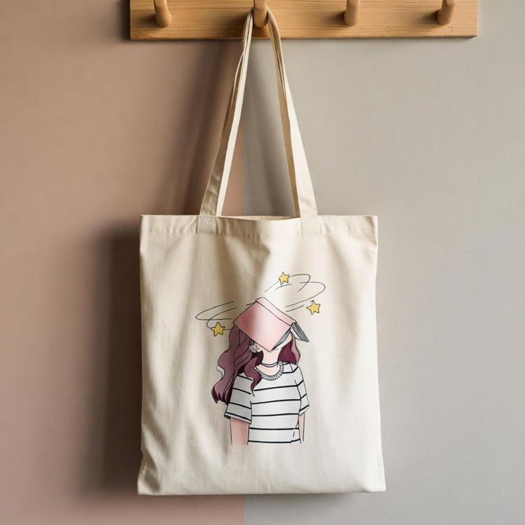 Cream tote bag with a stack of books and a soft pink floral illustration.