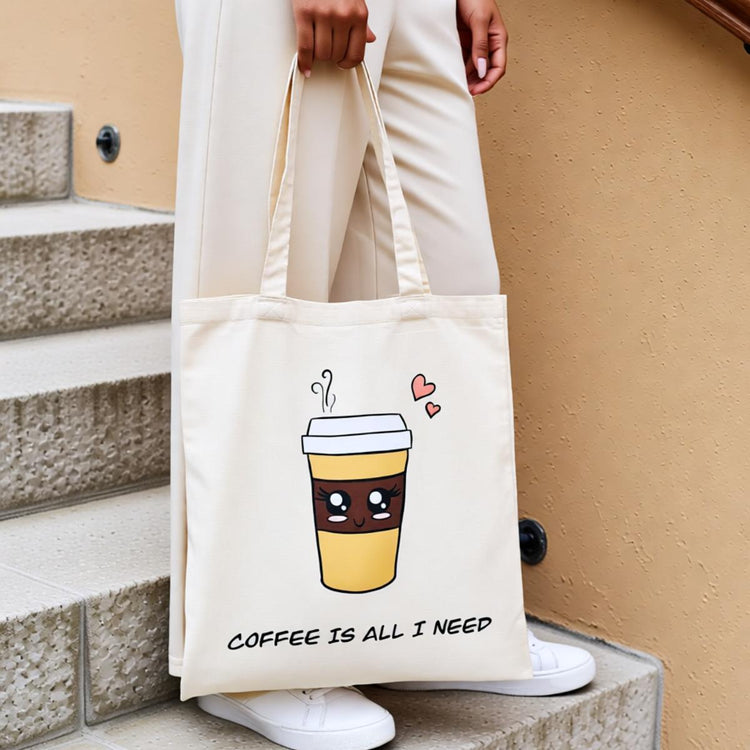Cream tote bag with a takeaway coffee cup illustration and coffee-themed lettering.