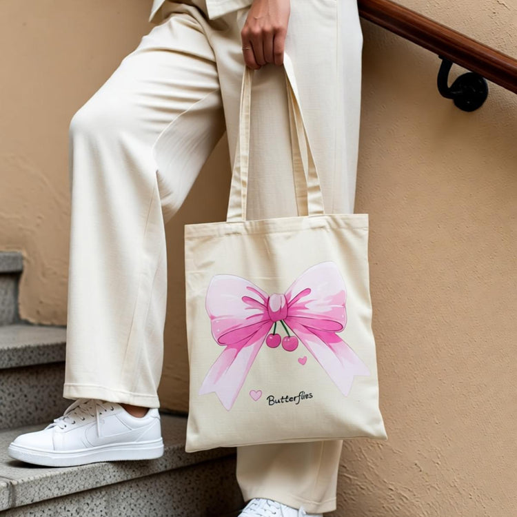 Cream tote bag with a large pink butterfly illustration.