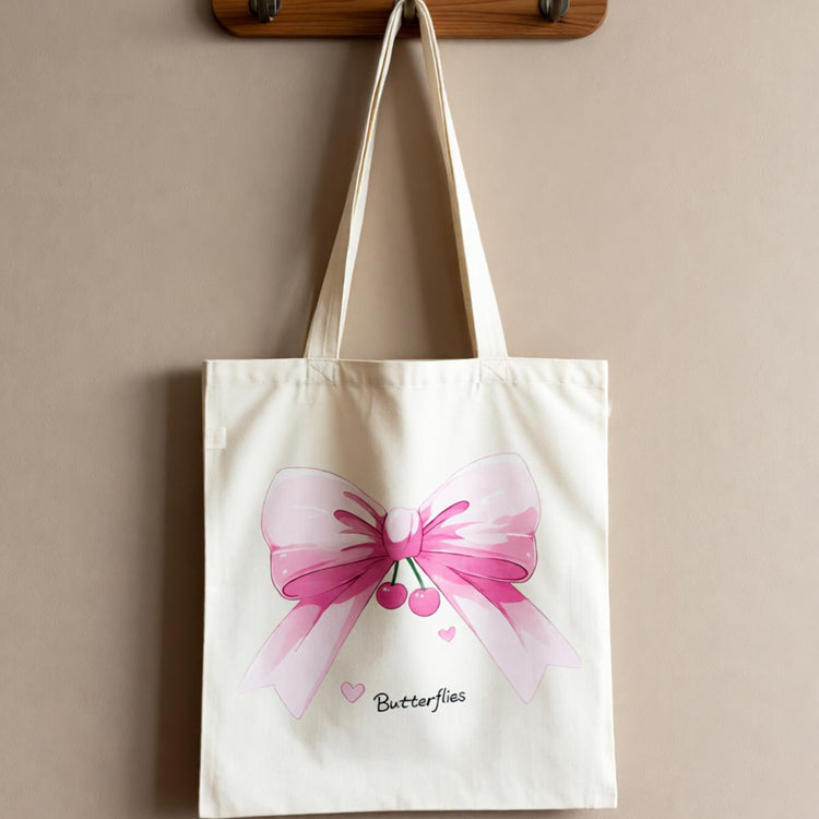 Cream tote bag with a large pink butterfly illustration.