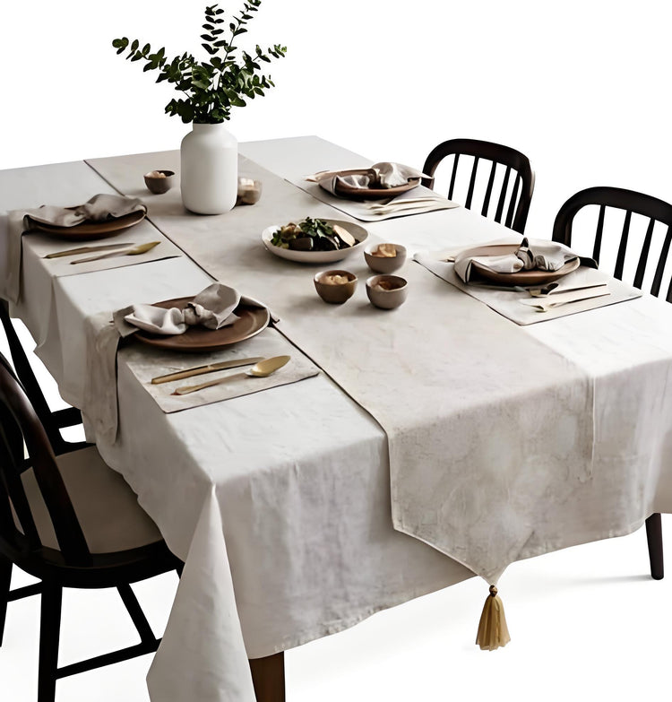 Pale gold patterned table runner with matching placemats on a set dining table.